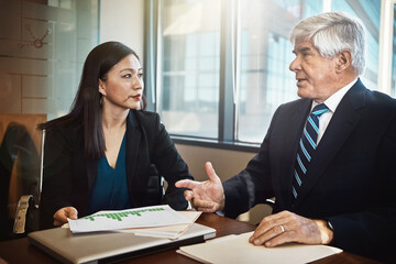 Business man, woman and documents for discussion with graphs, stats and information for financial compliance. Risk analyst, paperwork and senior entrepreneur with charts, info and review in office