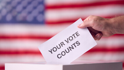 Hand Casting Ballot With American Flag