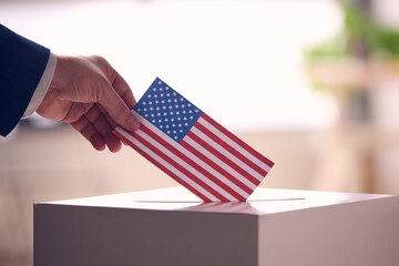 Person Casting Ballot With American Flag