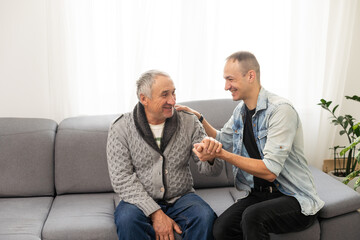Elderly son takes care of ill father 
