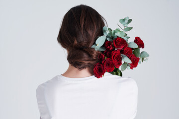Woman, red roses and valentines day with flower bouquet for anniversary or gift on a white studio...