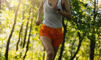 Woman runner running on forest trail © lzf