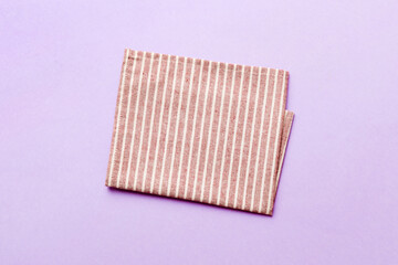 top view with red empty kitchen napkin isolated on table background. Folded cloth for mockup with copy space, Flat lay. Minimal style