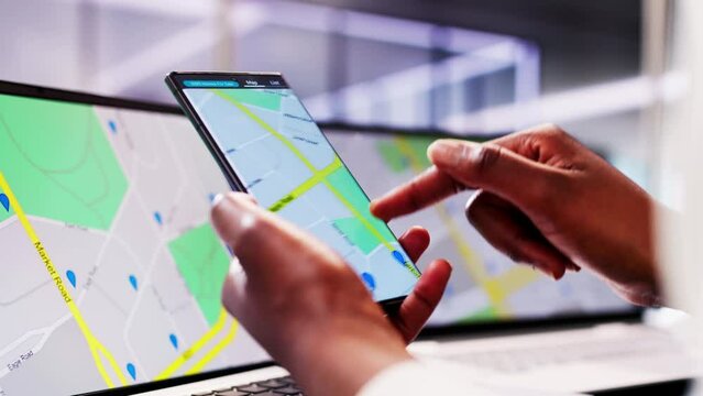 Real Estate Agent Locating Property with GPS Navigation Map on Smartphone for African American Client
