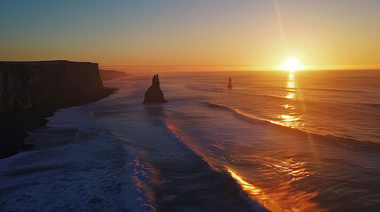 Obraz premium Stunning sunset over Reynisfjara beach with dramatic cliffs and ocean waves