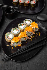 Sushi set composition on black background. The Art of Japanese Cuisine. Food photography for menu and sushi bar decoration