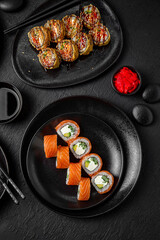 Sushi set composition on black background. The Art of Japanese Cuisine. Food photography for menu and sushi bar decoration
