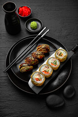 Sushi set composition on black background. The Art of Japanese Cuisine. Food photography for menu and sushi bar decoration