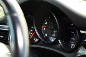 Speedometer and tachometer inside of modern car, closeup