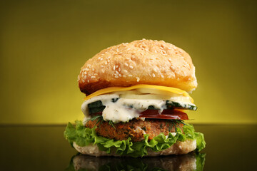 Delicious vegetarian burger on mirror surface against olive background