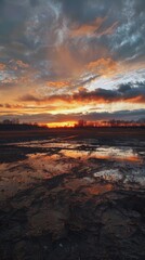 Fototapeta premium Sunset reflecting on wet muddy field