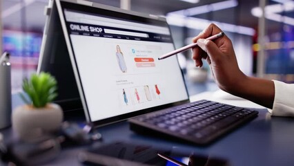 African American Woman Online Shopping for Luxury Clothes on Laptop Screen: Digital Marketing Professional