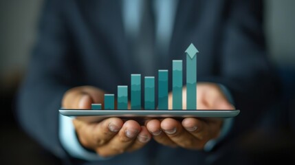 Businessman holding a tablet with a rising bar graph, symbolizing business growth, success, and financial progress in a corporate environment.