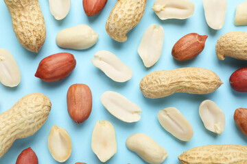 Fresh peanuts on light blue background, flat lay