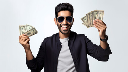 Man wearing sunglasses and smiling, holding dollar bills in each hand, representing wealth, success, and financial freedom.