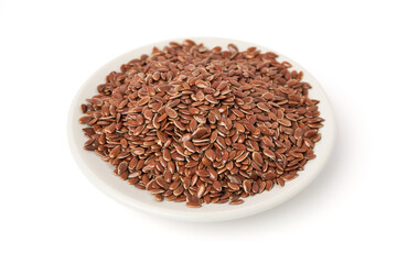Brown flax seeds on white plate isolated on white background. Brown Flax Seed is rich in nutrients such as dietary fiber and essential fatty acids that are beneficial to the body.