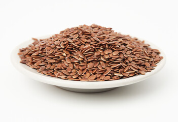 Brown flax seeds on white plate isolated on white background. Brown Flax Seed is rich in nutrients such as dietary fiber and essential fatty acids that are beneficial to the body.