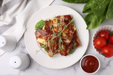 Tasty sandwich with bacon and microgreens served on white marble table, flat lay