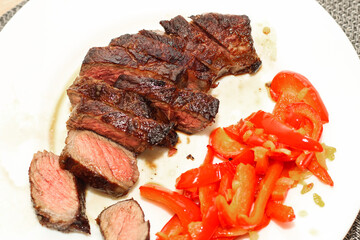Prepared striploin steak with stewed pepper