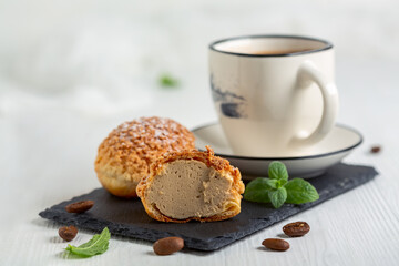Choux creams and a cup of coffee.
