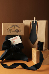 Concept of international father's day, gifts and greetings, on a brown background.