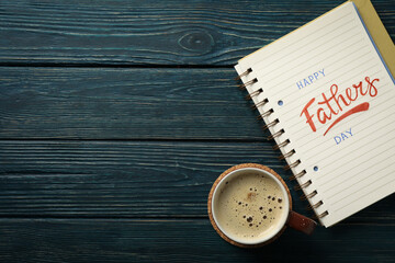 World father's day concept, with notebook on cup on blue background.