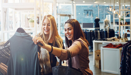 Fashion, shopping and friends with decision for clothes, sales and discount promotion at mall. Smile, retail shop and customer with fabric at boutique for purchase choice with women or girls laughing