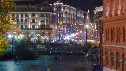 People walking on Manezh Square at night in Moscow. Tverskaya Street is in the background timelapse