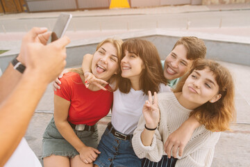 Best friends taking selfie outdoors with backlighting - Happy friendship concept with teenagers having fun together.
