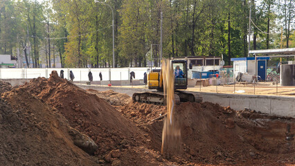 Yellow excavator on a construction site timelapse