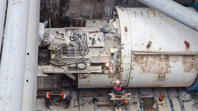 Welder fixing tunnel roring machine at subway construction site timelapse