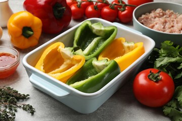 Making stuffed peppers. Vegetables and ground meat on grey table