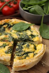 Delicious pie with spinach on table, closeup
