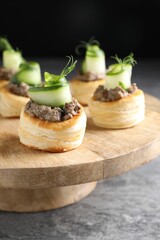 Delicious puff pastry with mushrooms, cucumber and dill on grey table