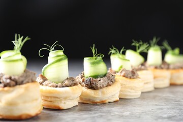 Delicious puff pastry with mushrooms, cucumber and dill on grey table