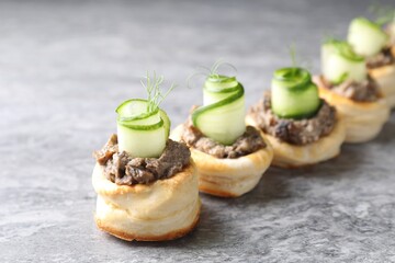 Delicious puff pastry with mushrooms, cucumber and dill on grey table
