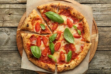 Delicious Margherita pizza on wooden table, top view