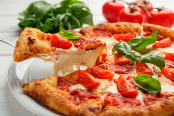 Taking piece of delicious Margherita pizza at white table, closeup