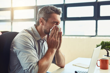 Man, sick and blowing nose in office for healthcare, flu season or allergies with congestion. Male entrepreneur, medical and tissue for FLiRT COVID or infection in startup, bacteria or corona virus