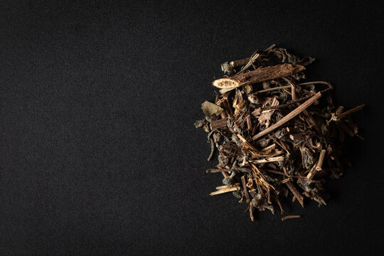 A pile of Dry Organic Bhringraj (Eclipta prostrata) leaves, isolated on a black background. Top view