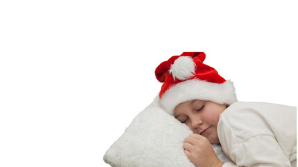 Young child wearing a santa hat sleeps soundly, embracing a soft white pillow, isolated on a white background, evoking the innocence and tranquility of the festive season