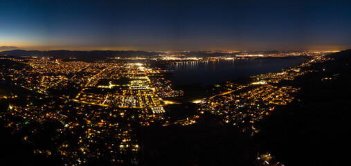 Fototapeta premium Stunning aerial night time view of Lake Elsinore with mountain backdrop Riverside County California USA