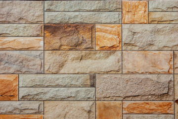 Seamless old sandstone brick wall background texture. Tileable antique vintage stone blocks or tiles surface pattern. Rustic cottagecore wallpaper or backdrop.