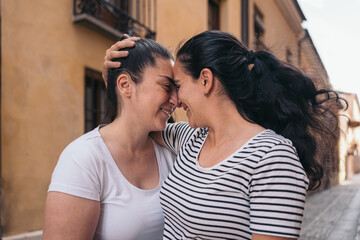 Intimate moment between same-sex couple. Portrait of a smiling lgbt couple embracing and touching foreheads