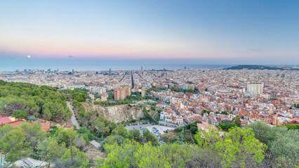 Obraz premium View of Barcelona day to night timelapse, the Mediterranean sea, The tower Agbar and The twin towers from Bunkers Carmel. Catalonia, Spain.