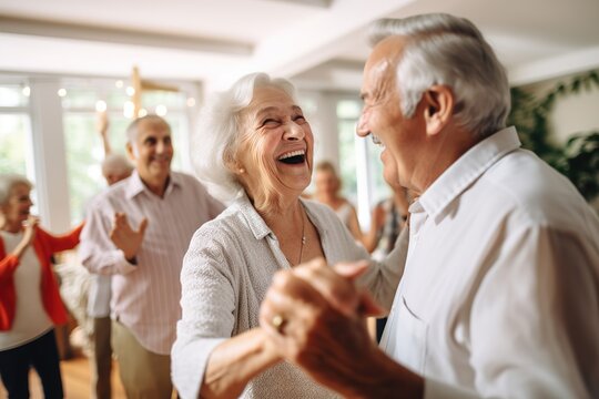 An elderly couple is dancing at a house party in an apartment for elderly friends, smiling and enjoying chatting with friends. Time for the elderly.
