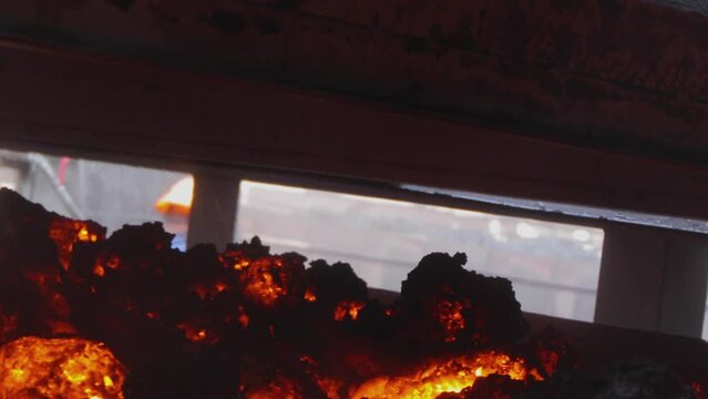 Coal coking process, coke oven coal making process. Hot coke coal leaves the furnace.