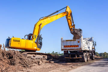 Fototapeta premium Construction Industrial Excavator Machine Earthworks Loading Truck