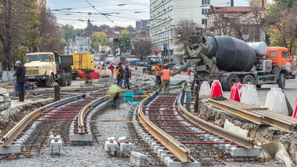 Pouring ready-mixed concrete after placing steel reinforcement to make the road by concrete mixer...