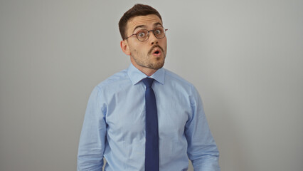 Young hispanic man with beard and glasses in blue shirt isolated against white background.